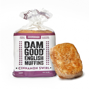 Packaged cinnamon swirl English muffin with 'Dam Good' branding on a white background