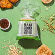 Load image into Gallery viewer, Packaged multigrain Dam Good English Muffins with ingredients on a green background
