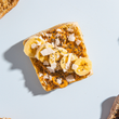 Load image into Gallery viewer, Sourdough Dam Good English Muffin Whole Wheat Toast with banana slices and coconut flakes on a light blue background
